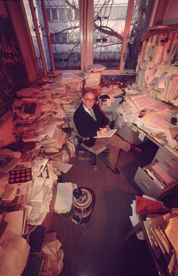 Mr. Dick physicist in his office among his documents CERN